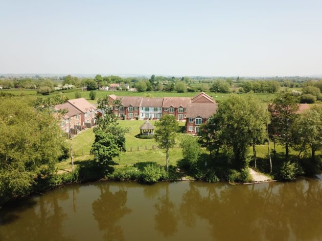 Aerial view of Lakeview’s holiday cottages in Somerset with 12-acre lake.
